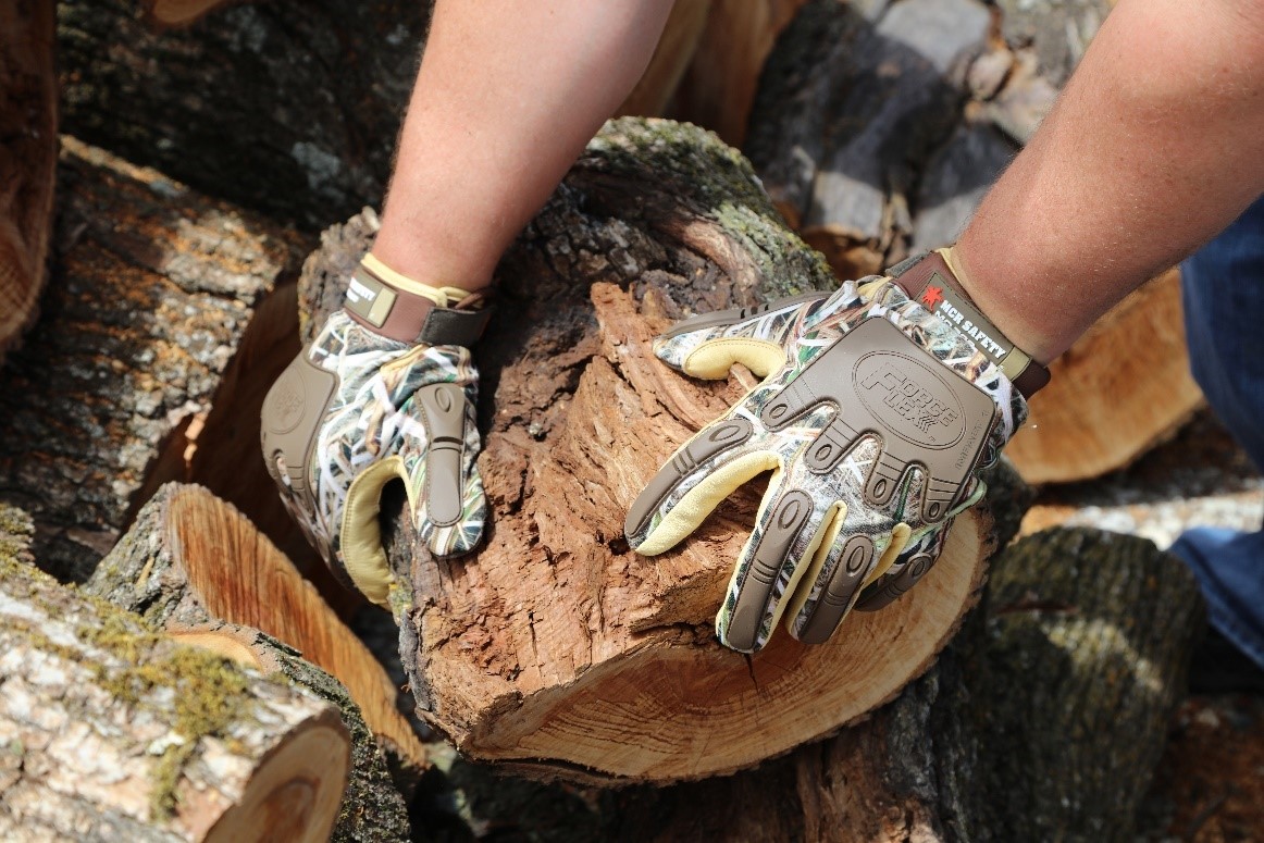 Camo Gloves holding wood